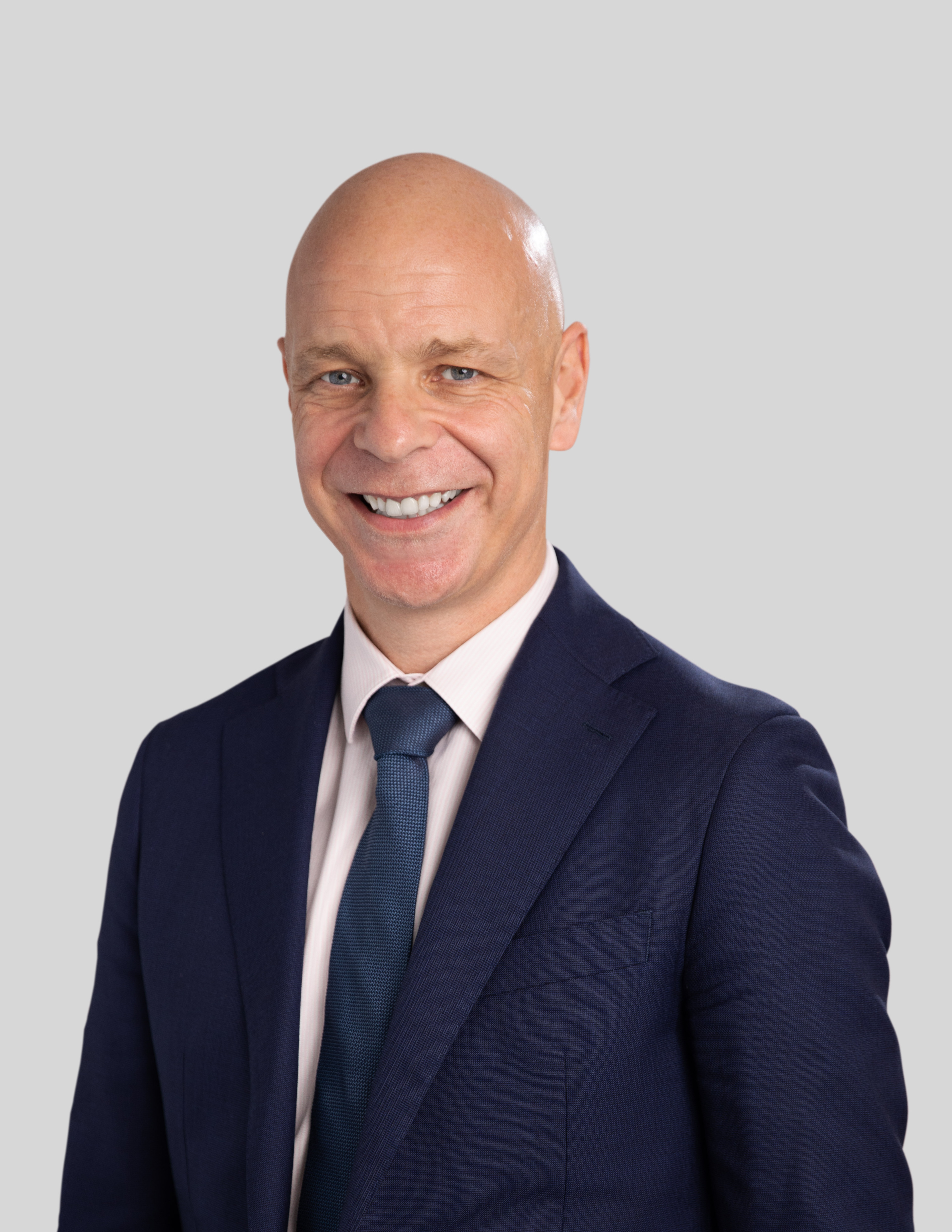 Executive Chris Dale MEGT clothing person man smile human face formal wear blazer collar dress shirt outerwear white-collar worker gentleman headshot businessperson shirt pocket dress suit button suit Chris Dale MEGT