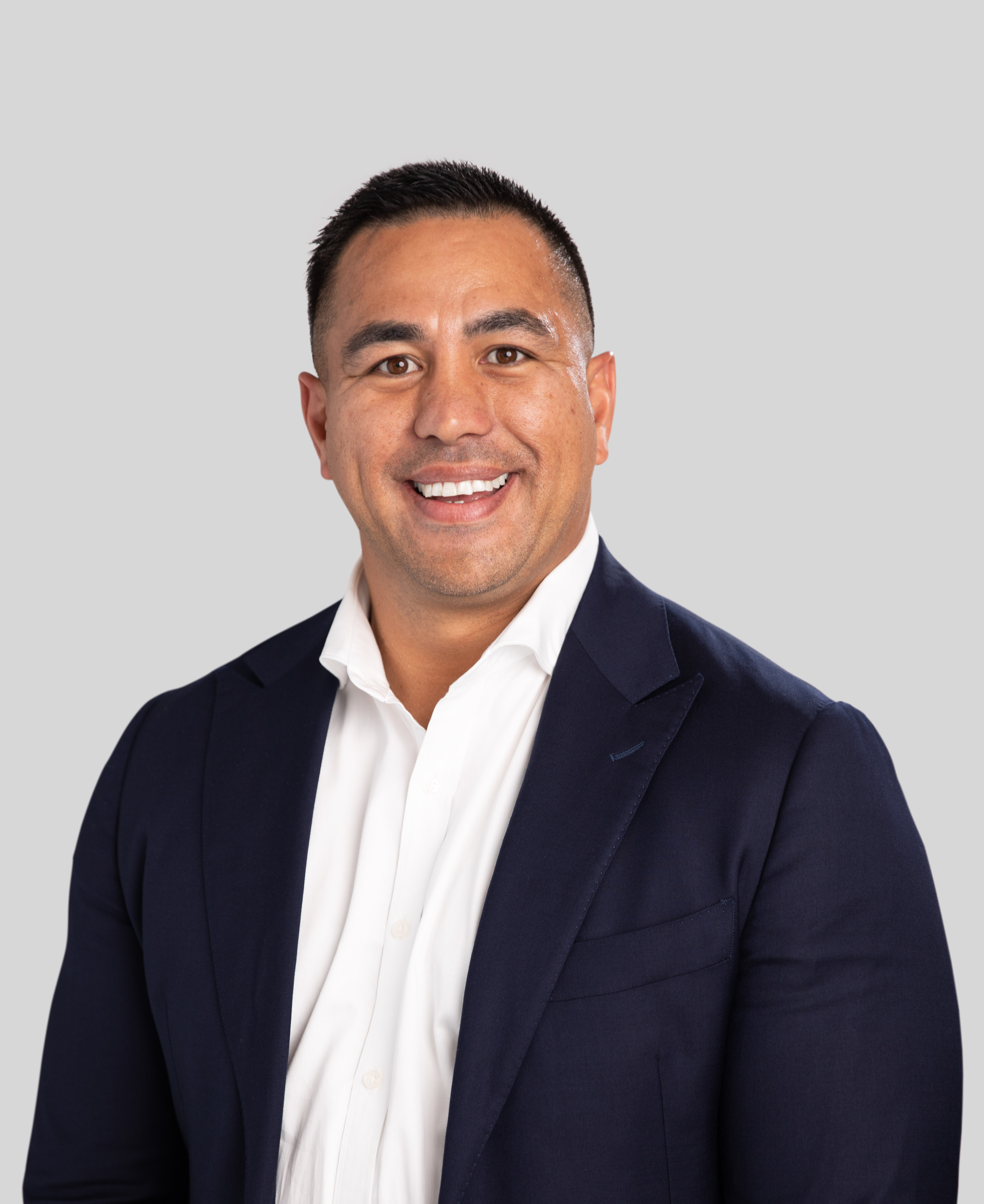 MEGT Executive Daniel Reihana clothing human face person smile man formal wear blazer collar headshot dress shirt shirt outerwear gentleman white-collar worker businessperson top chin forehead suit