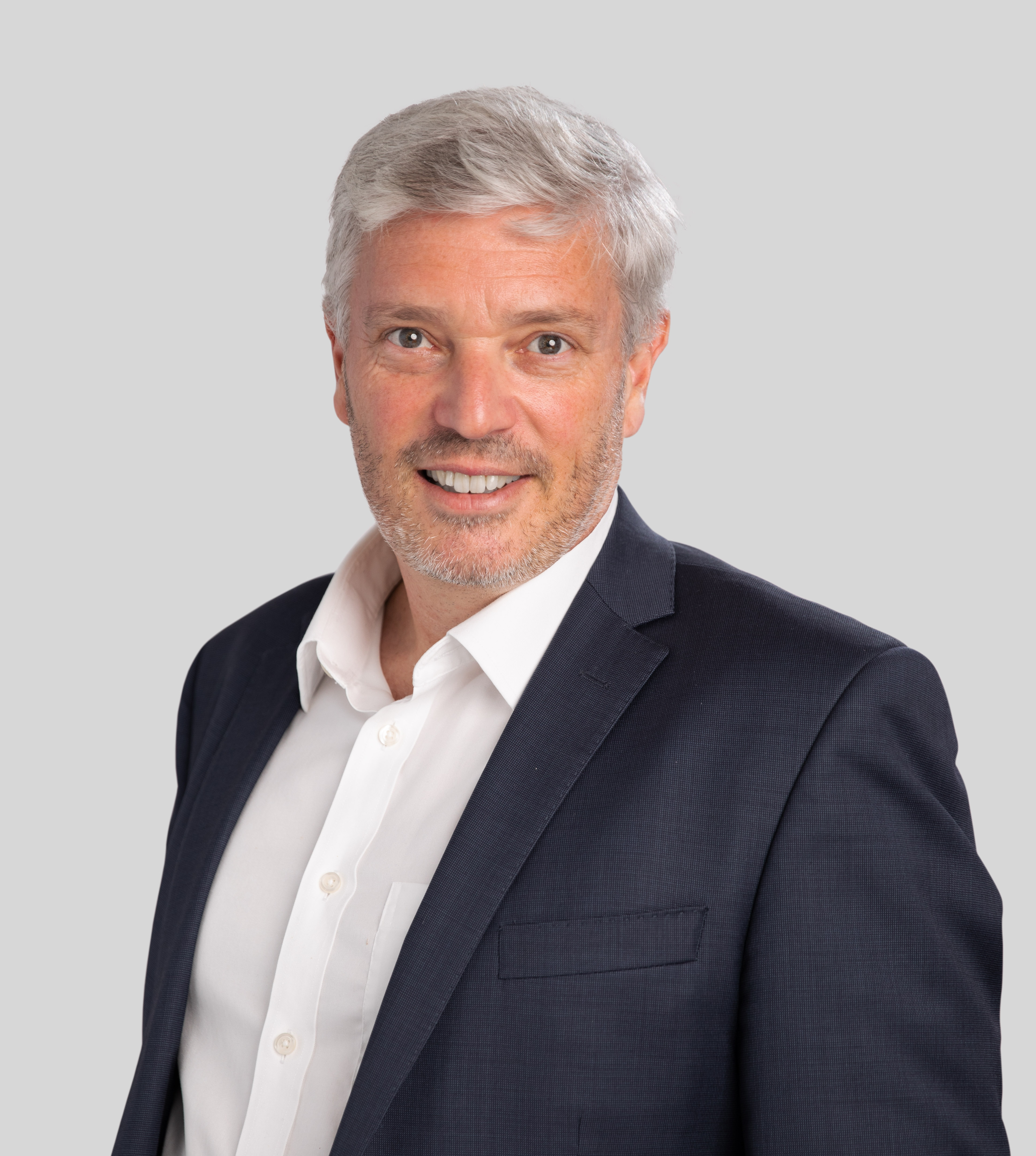MEGT Executive Chief Executive Officer Matthew Hick clothing person human face man smile formal wear blazer collar dress shirt gentleman shirt outerwear businessperson white-collar worker coat dress suit