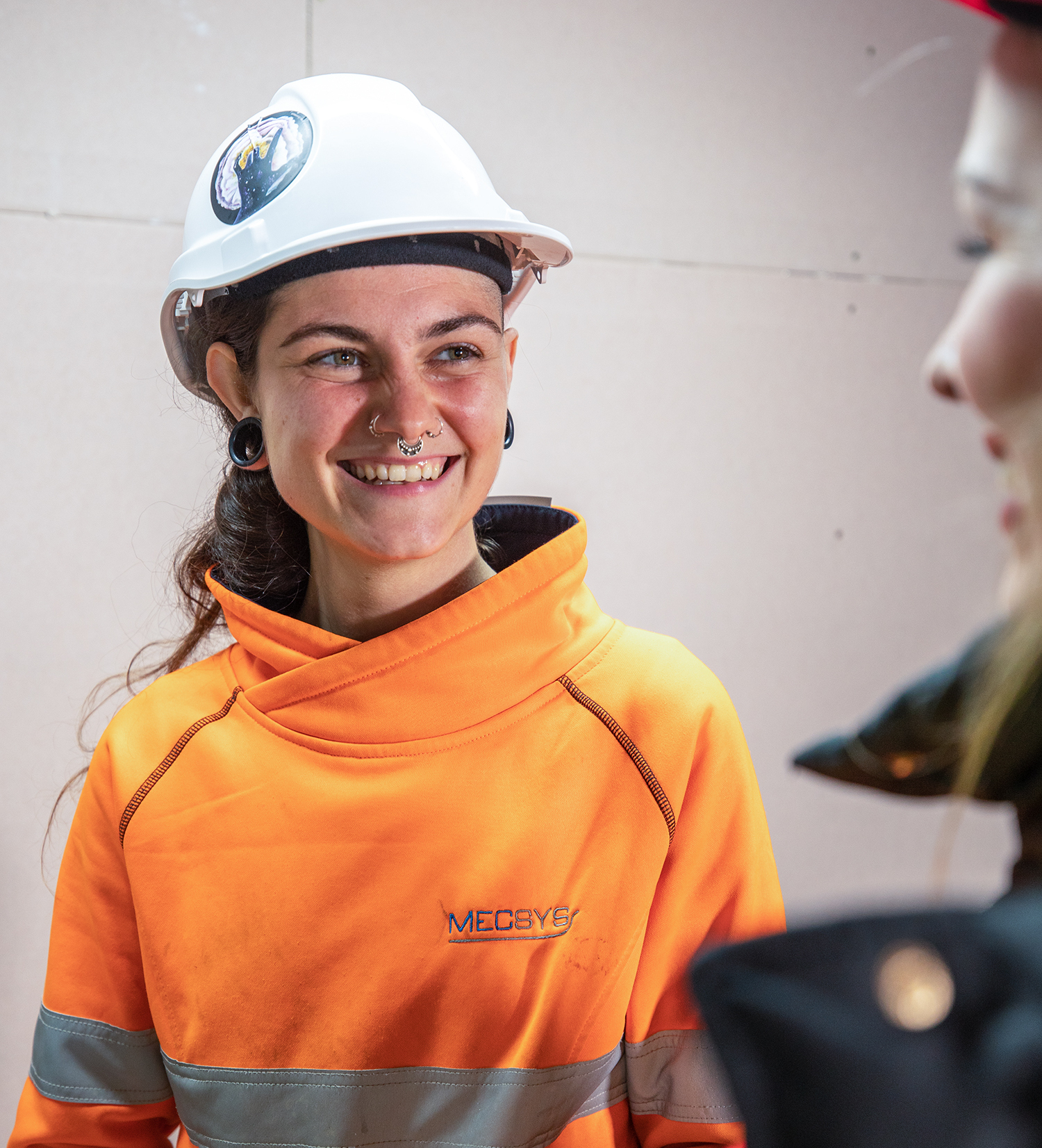 happy discussion indoors Employers Mentor Mentoring and Personal Support Services young woman construction apprentice or trainee with mentor blue-collar worker clothing engineer fashion accessory firefighter hard hat high-visibility clothing human face orange person personal protective equipment smile wearing workwear